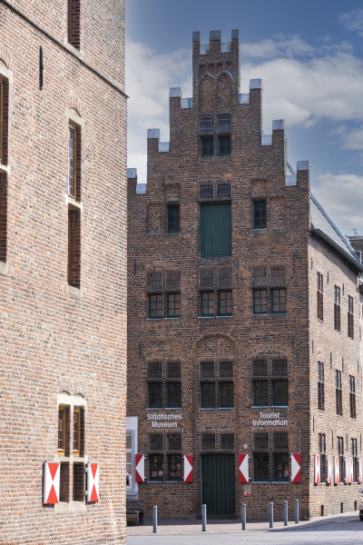 Blick auf das spätmittelalterliche Backsteinhaus mit Stufengiebel, in dem die Tourist-Information Kalkar untergebracht ist.
